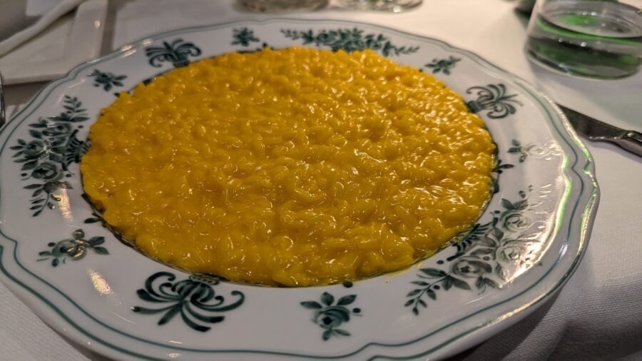 Milan Destination Guide: The Model of Fashion, Food, and Gothic Grandeur 13 Plate of yellow risotto dish
