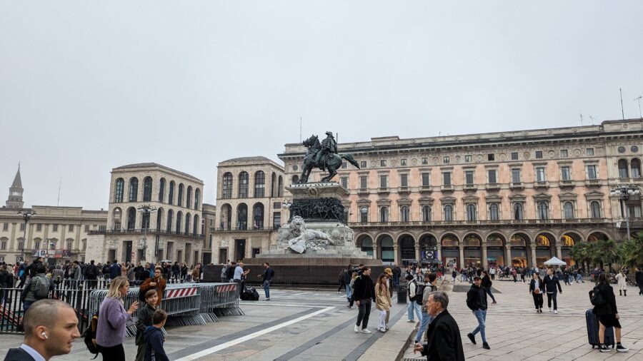 Milan Destination Guide: The Model of Fashion, Food, and Gothic Grandeur 6 Crowd near statue in urban square.