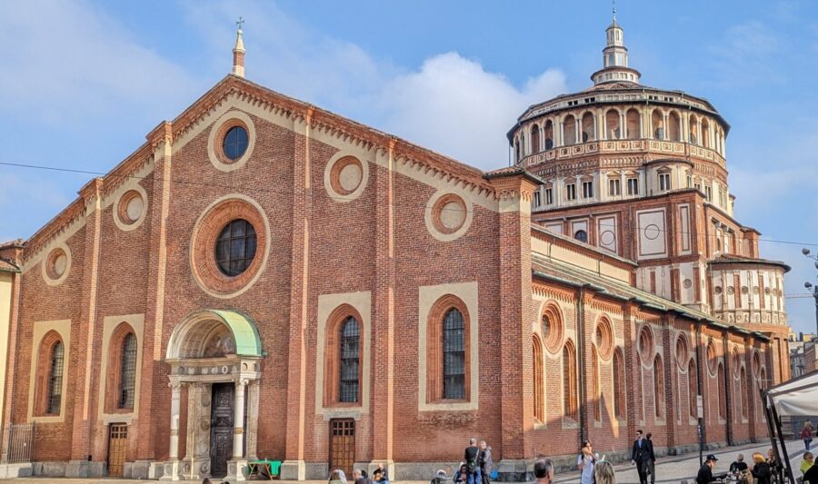 Milan Destination Guide: The Model of Fashion, Food, and Gothic Grandeur 10 Santa Maria delle Grazie with a round tower and people walking around